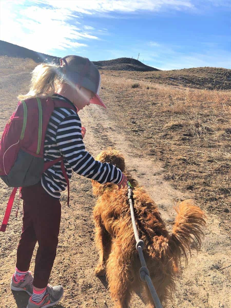 What to pack - Little girl wearing hiking backpack on hike in Colorado