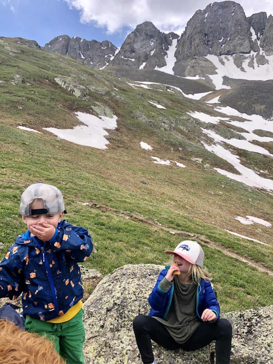 What to pack for snacks on a hike - Kids eating snack on hike in San Juan Mountains, Colorado