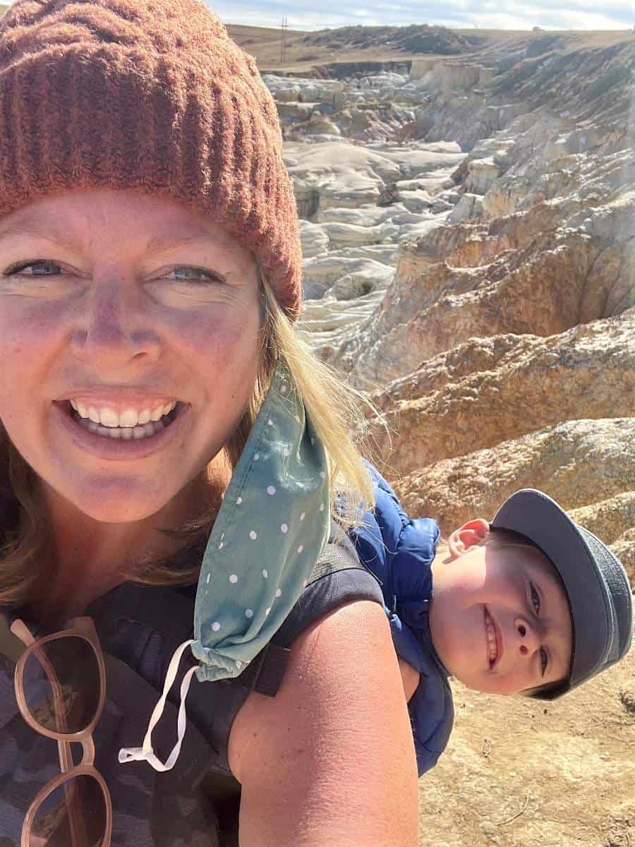 Son on mom's back in front of Paint Mines