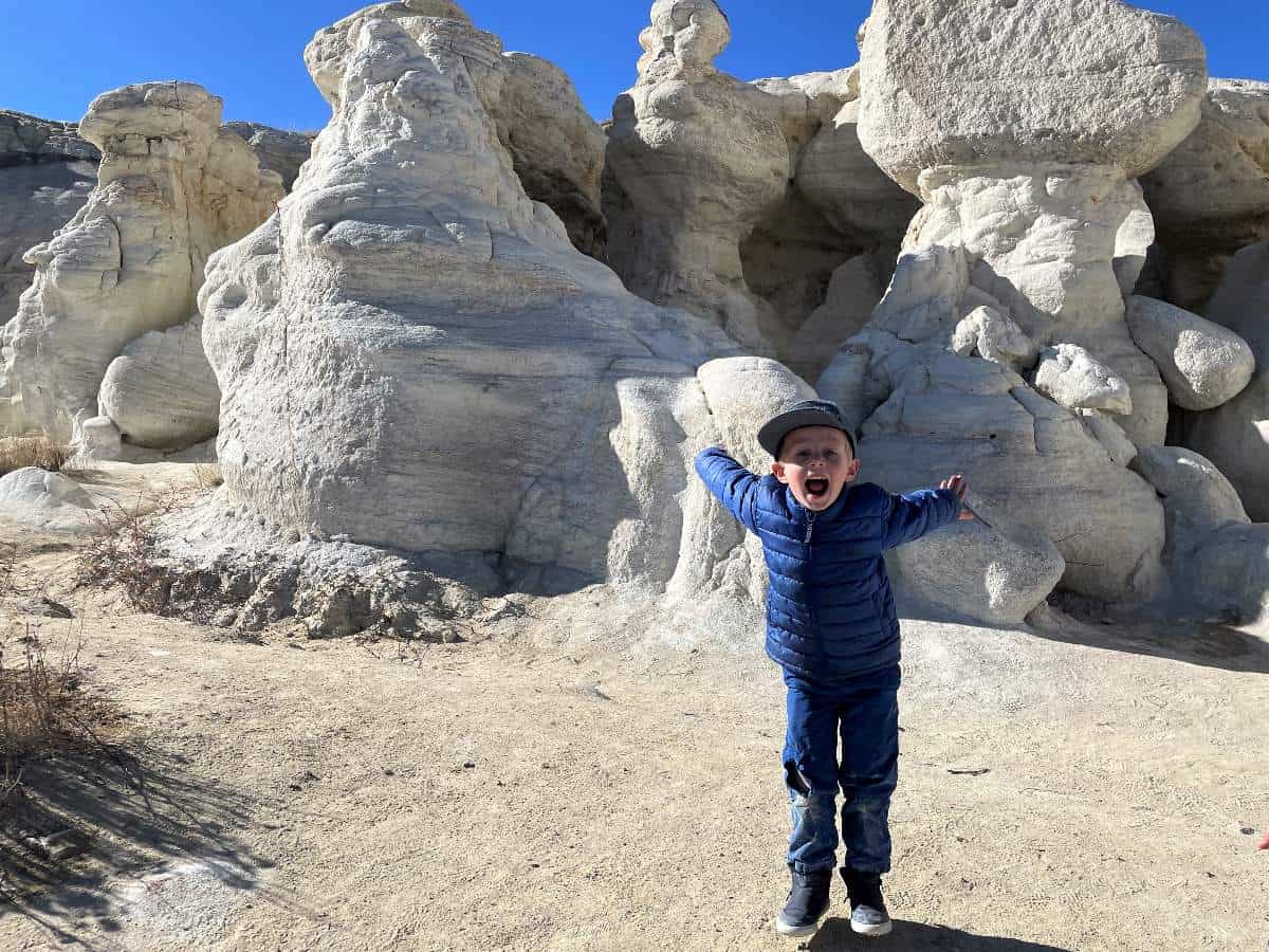 Boy in front of white rock at Paint Mines