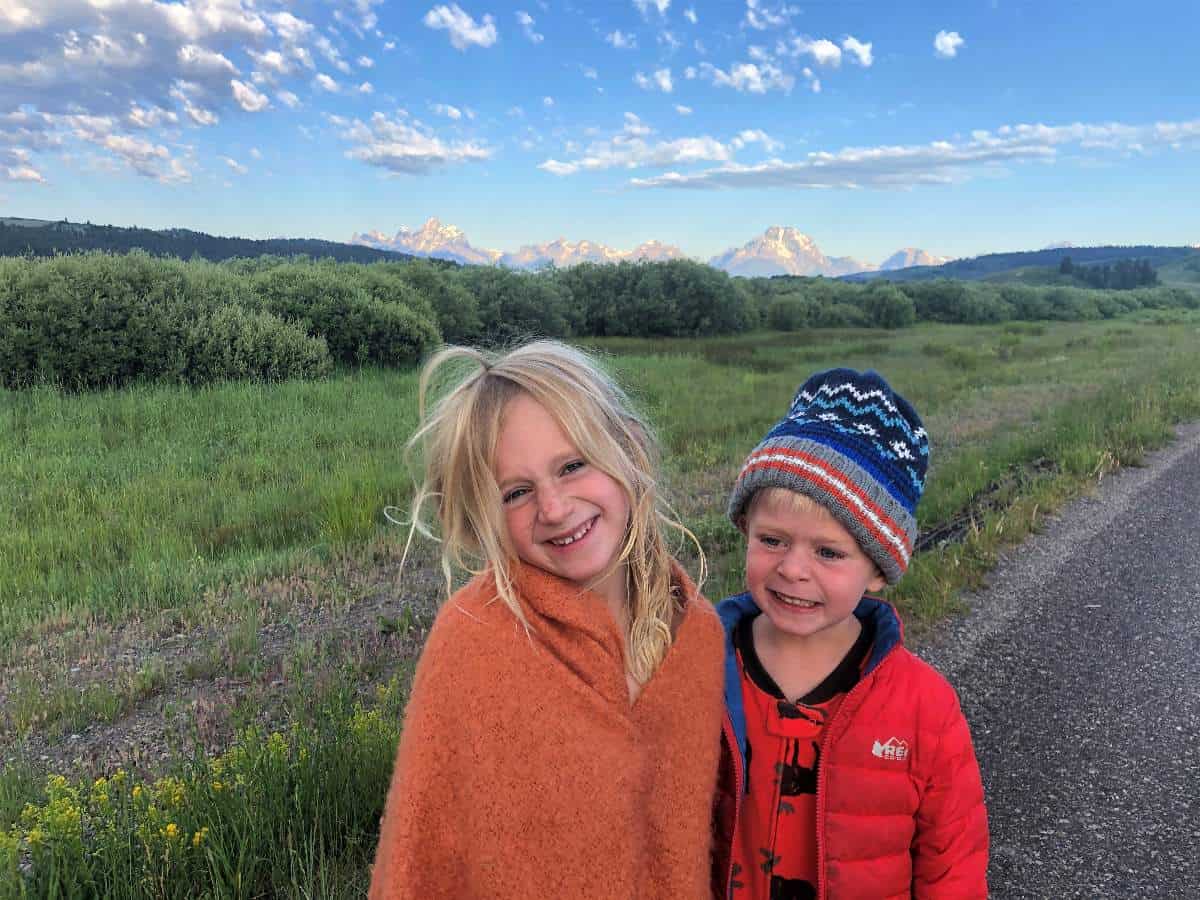Kids in front of Tetons at sunrise