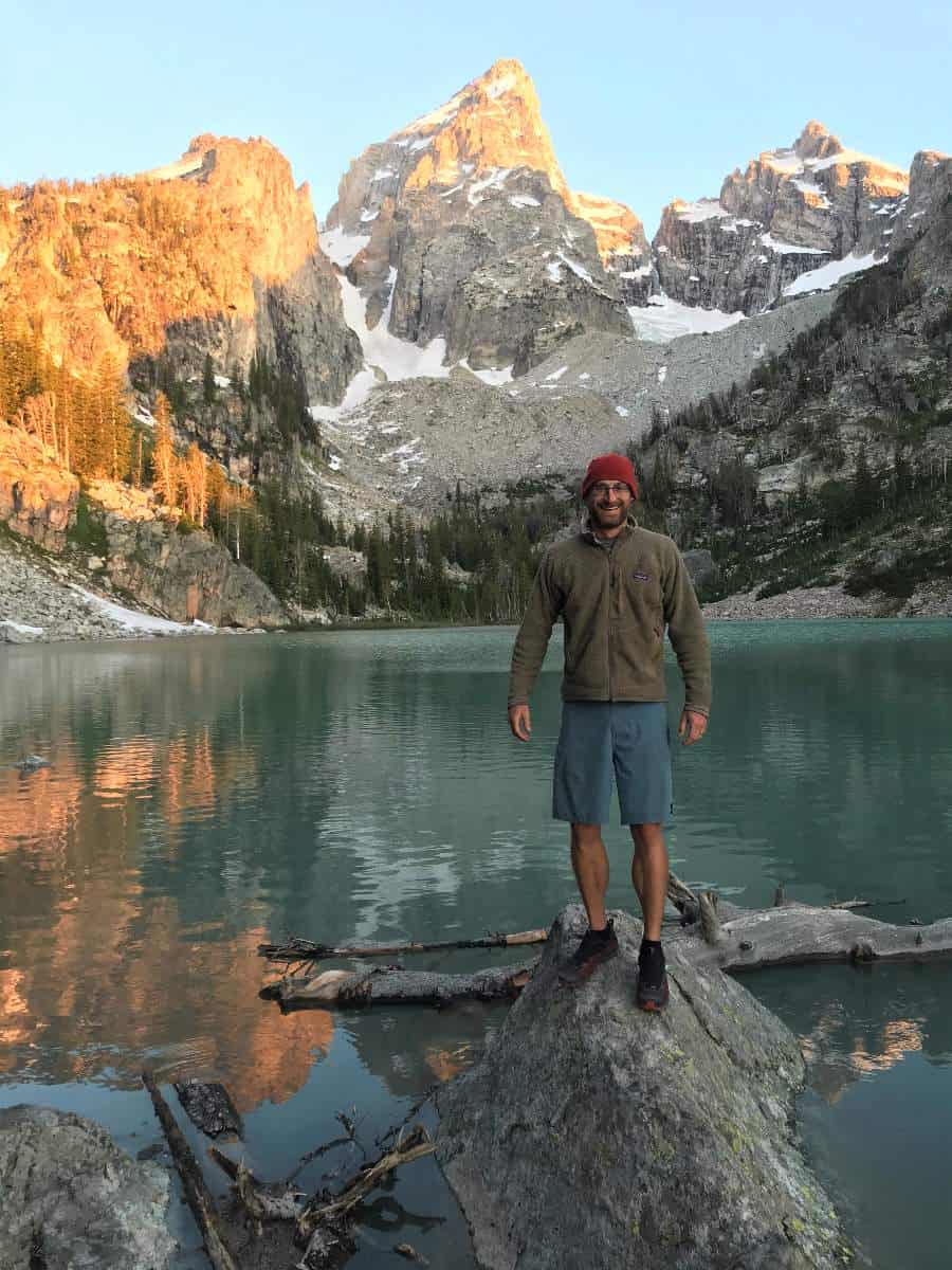 Standing on rock at sunrise at Delta Lake