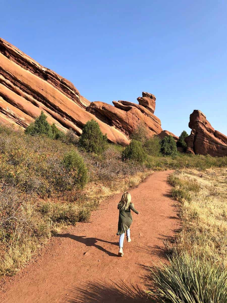 Girl running at Denver red rocks hike