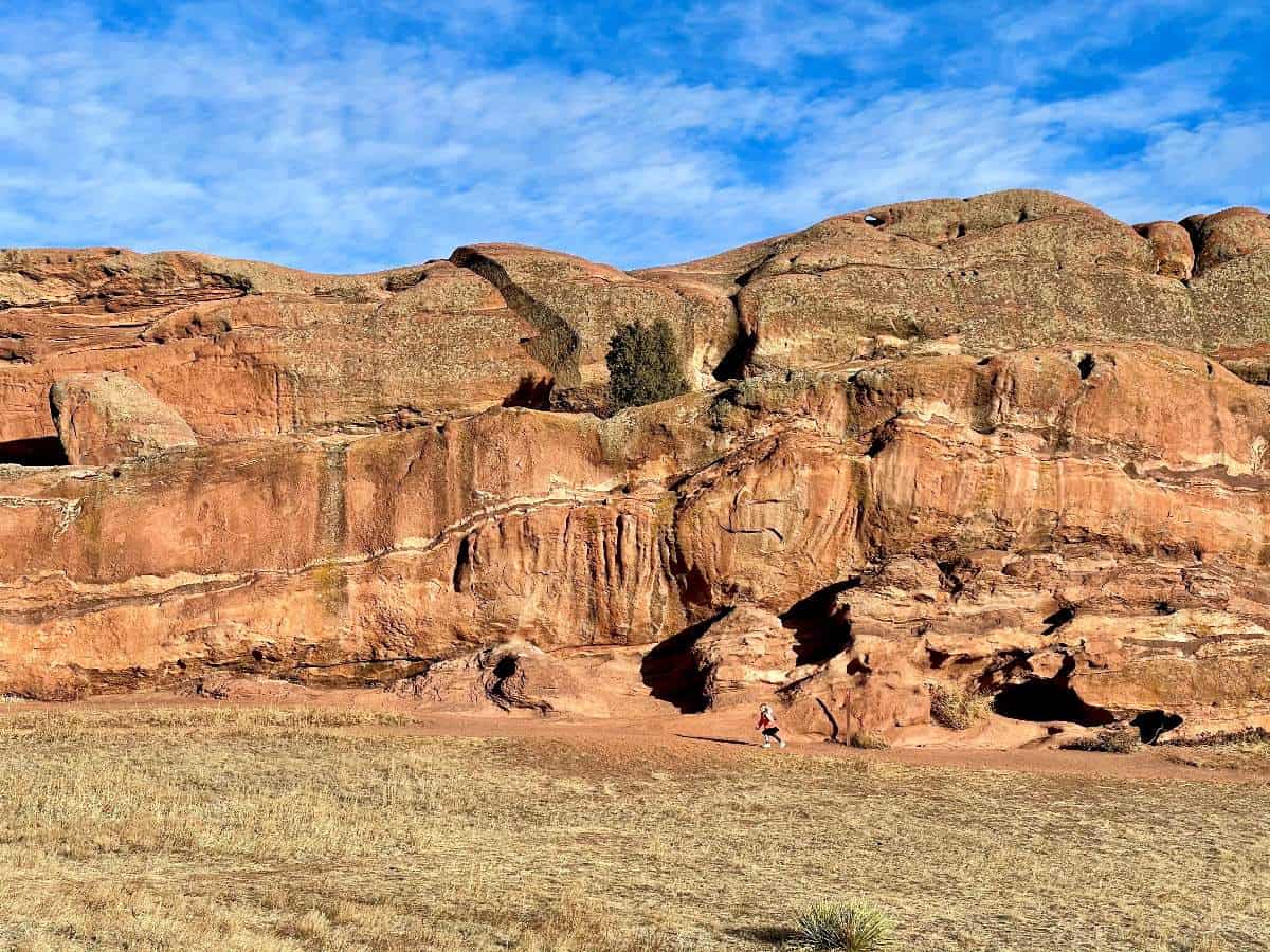 Girl running in front of red rocks on Denver kid hike