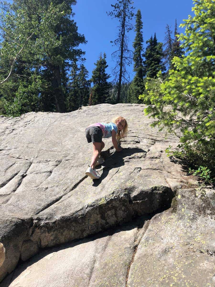 Girl climbing rocks on hike