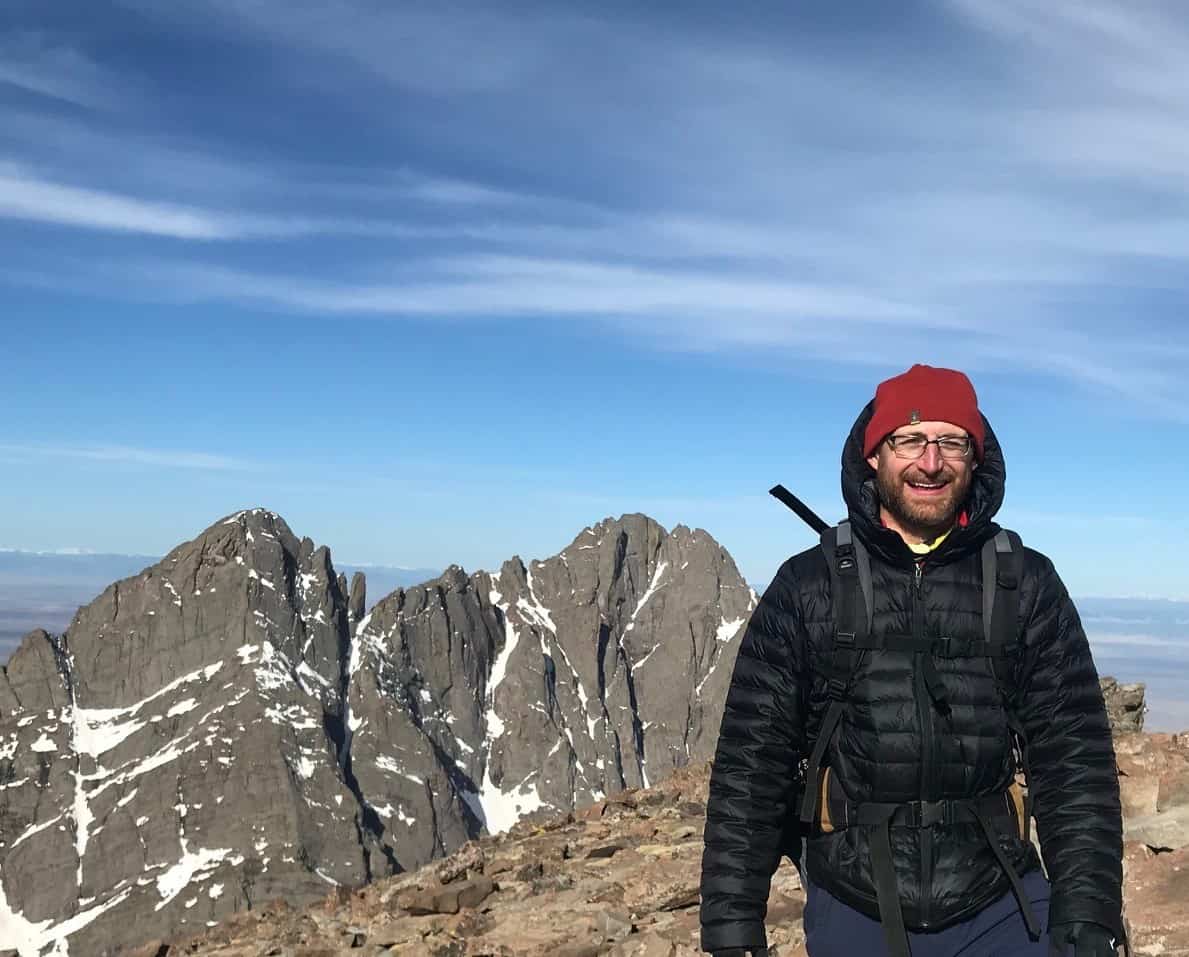 Hiker at top of 14er in Colorado