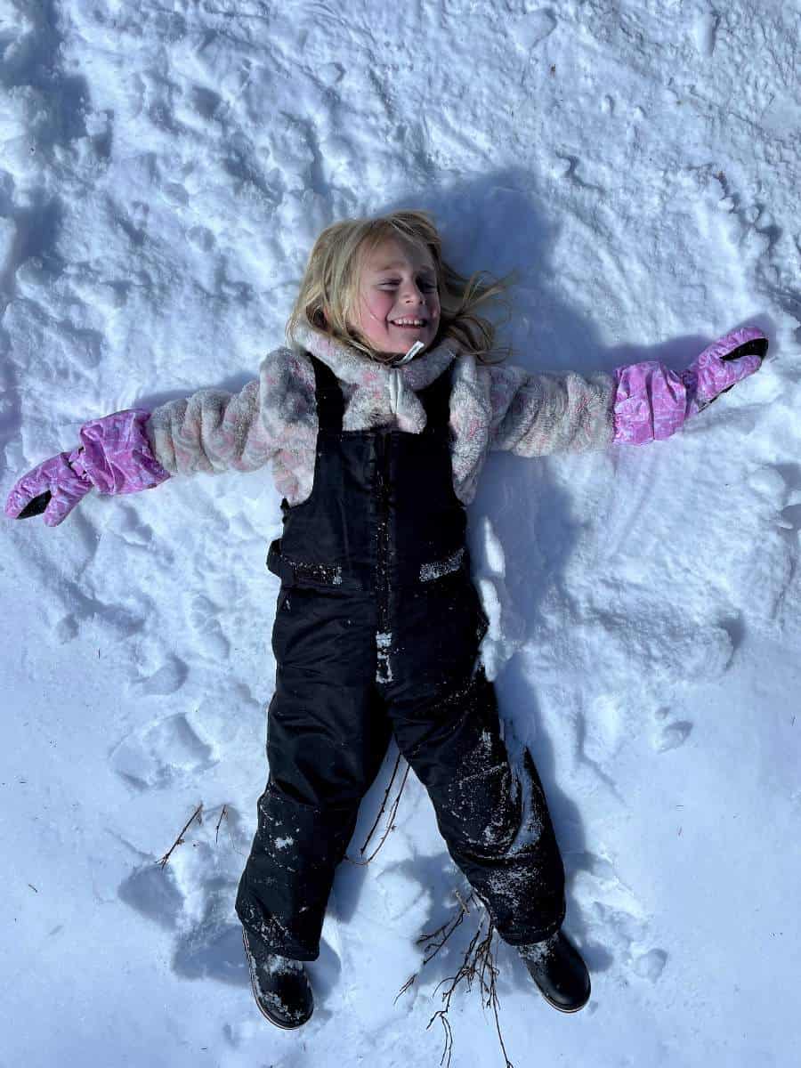 Girl making snow angel