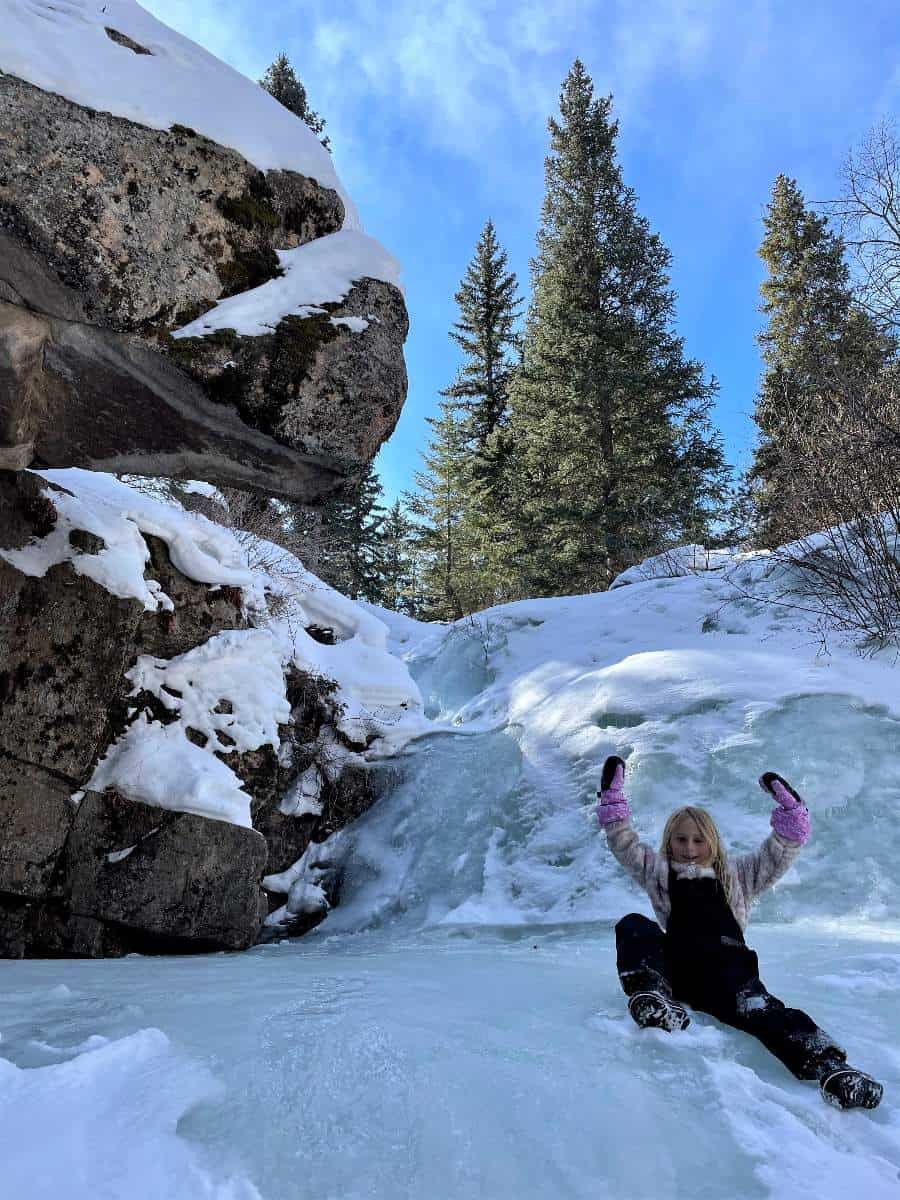 Girl sitting on a waterfall