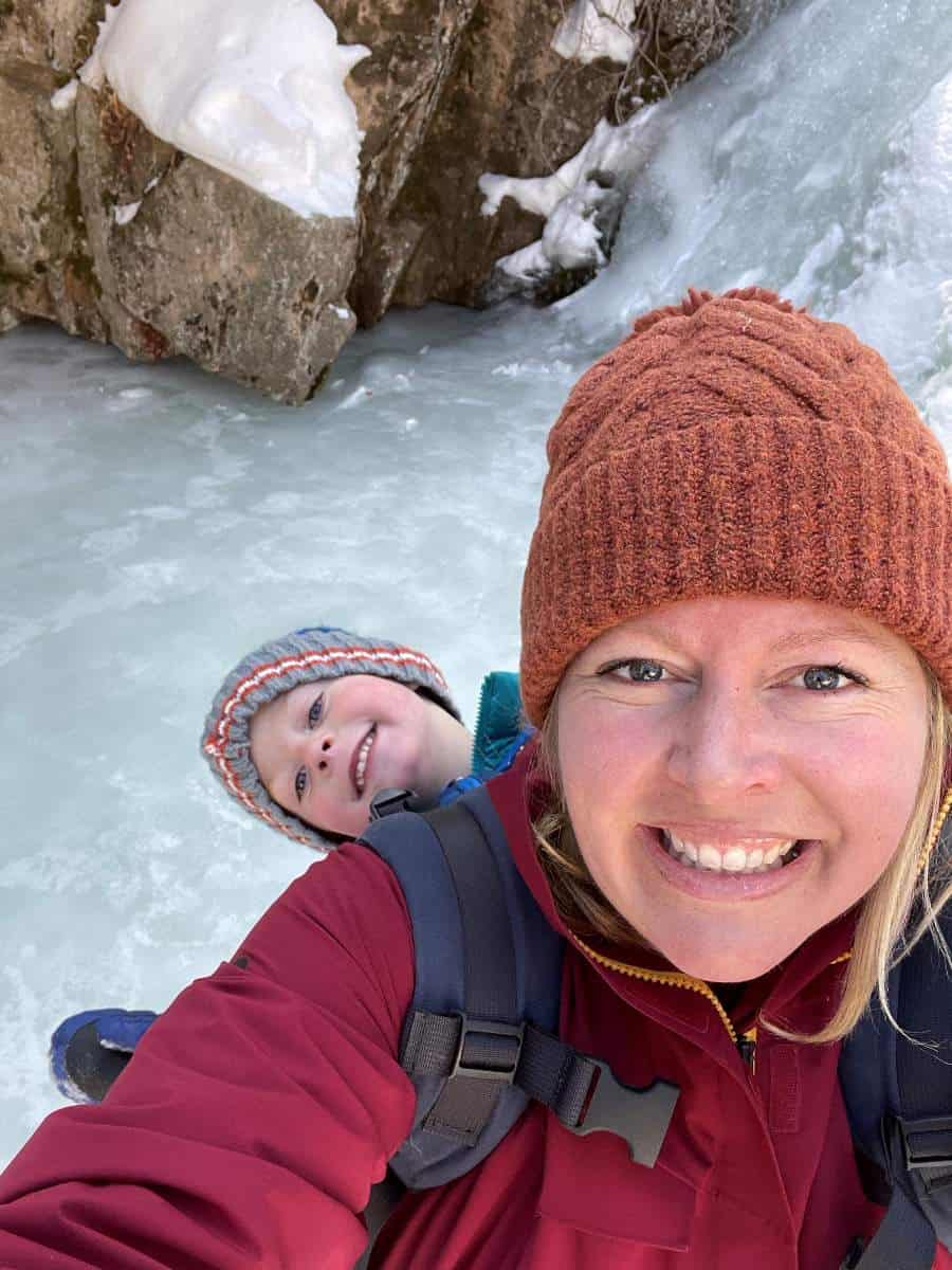 Mom and son on frozen waterfall