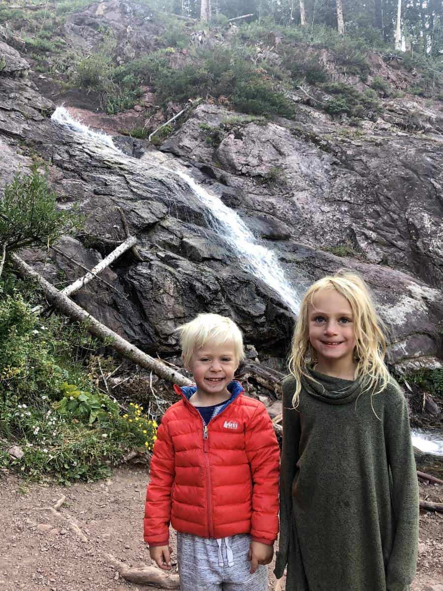 kids in front of waterfall 