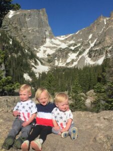 kids in 4th of July shirts in front of Dream Lake at Rocky Mountain National Park