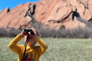 boy looking in binoculars at Roxborough State Park
