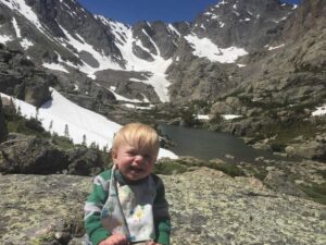 boy in front of sky pond lake in Rocky Mountain National Park