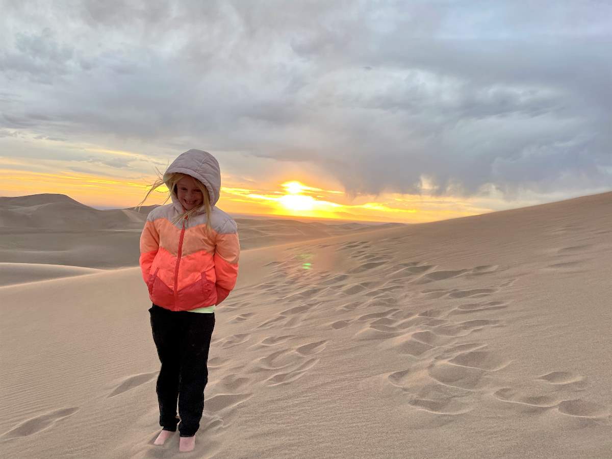 girl at sunset on dunes
