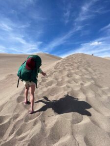 girl hiking in sand