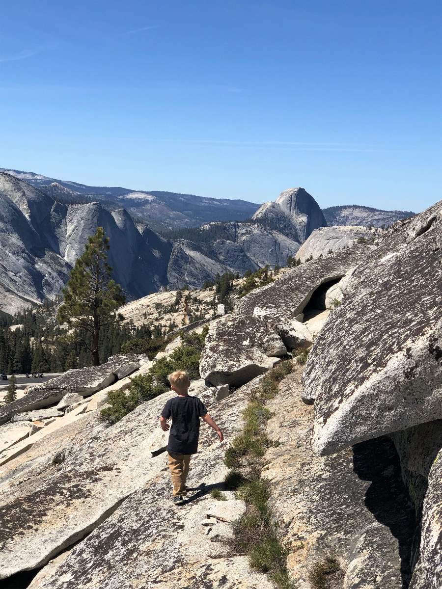 boy walking with Half Dome in view