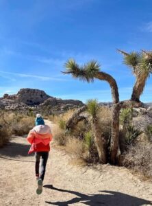 Girl running on a trail in Joshua Tree