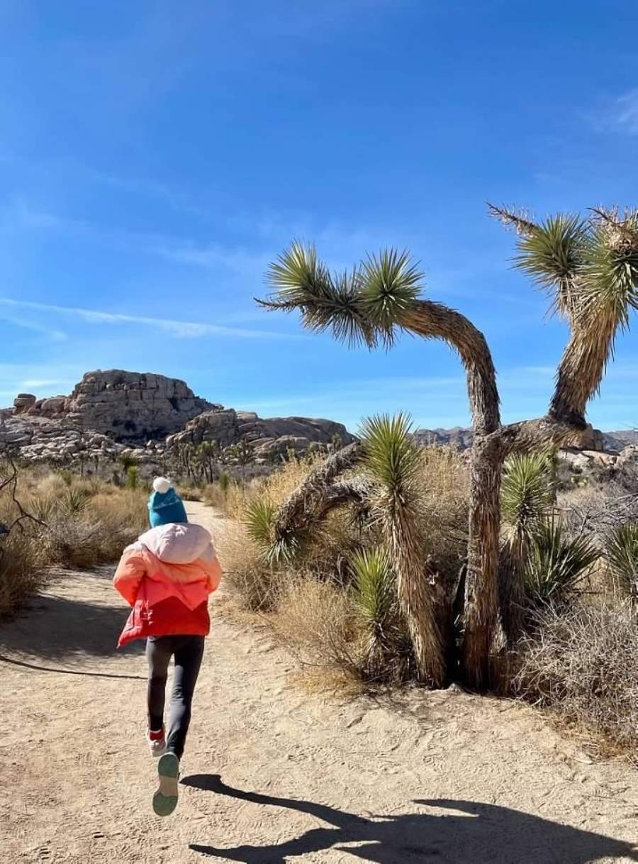 Girl running on a trail in Joshua Tree