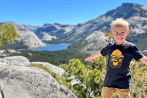 Boy at top of Olmsted Point looking at Tenaya Lake