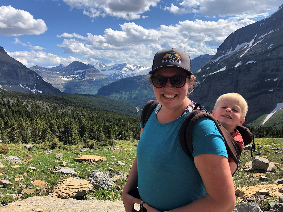 mom carrying son in hike