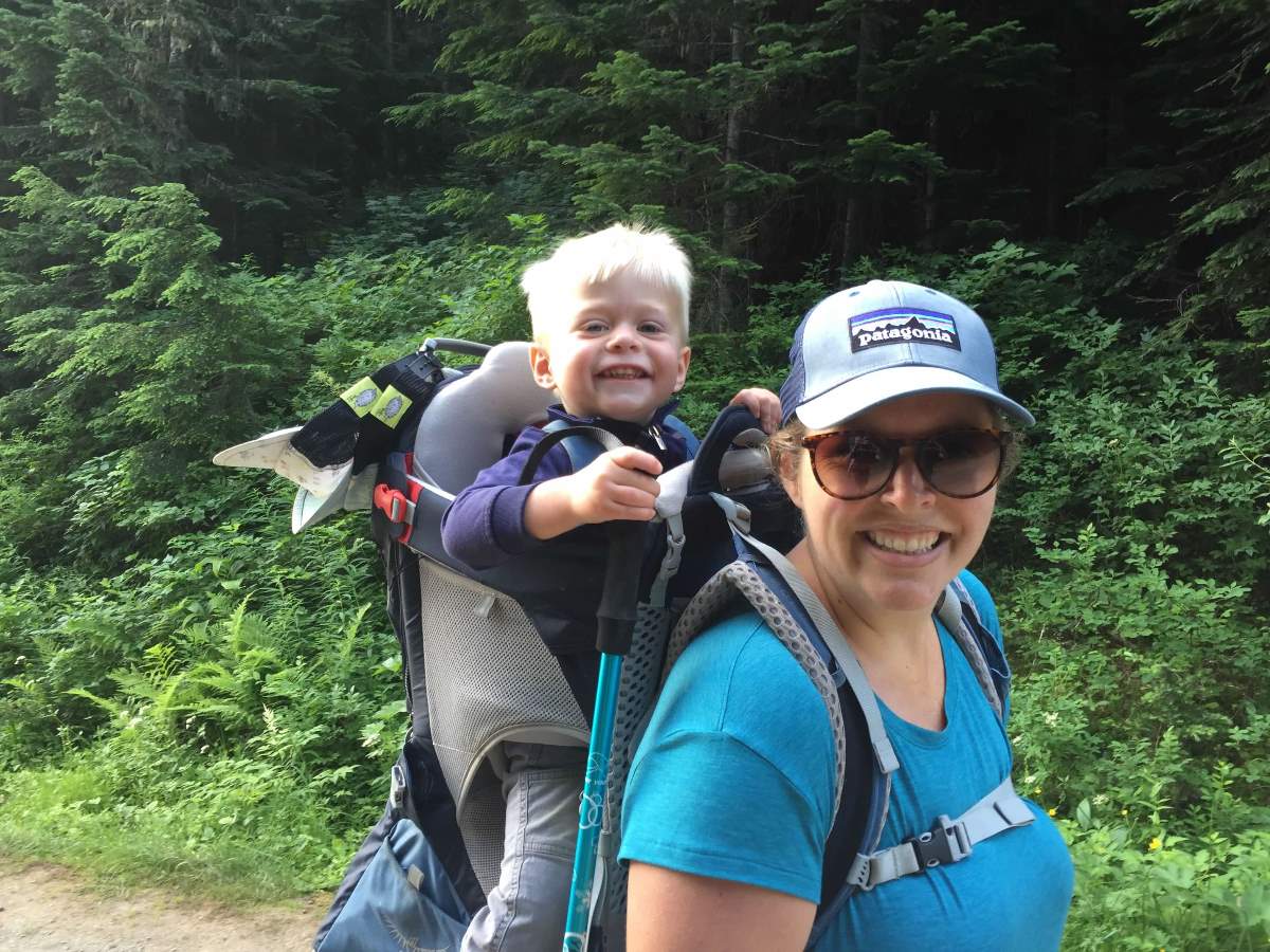 carrying child in backpack on hike