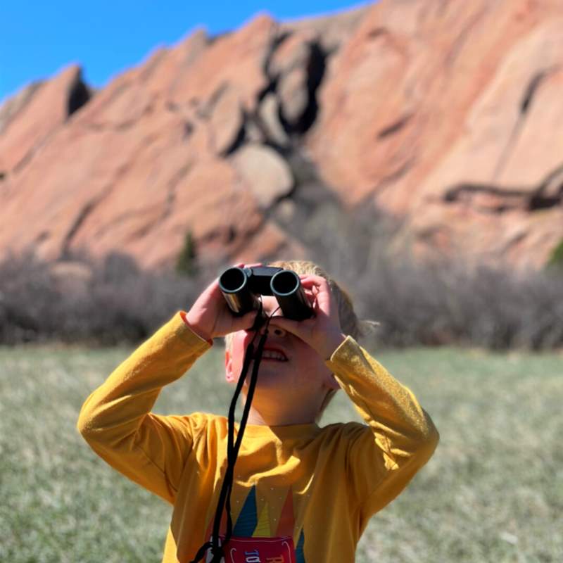 boy holding binoculars