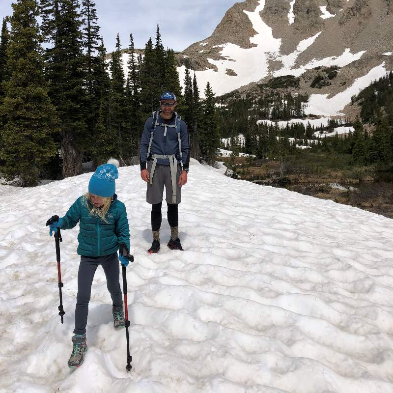 girl hiking with hiking poles