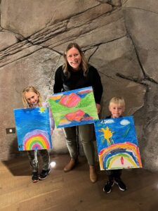 mom and kids with finished paintings