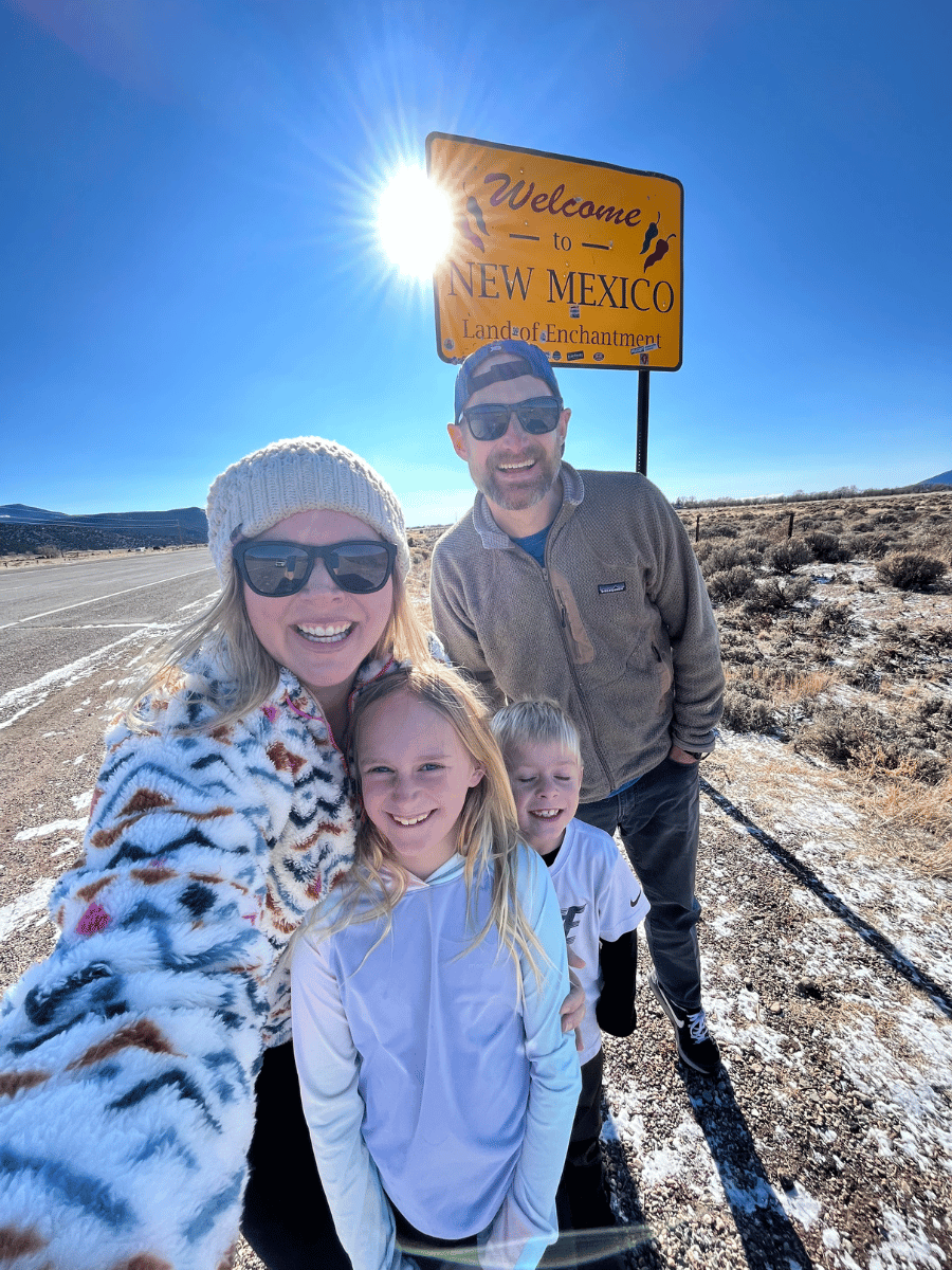Family selfie in front of Welcome to New Mexico sign