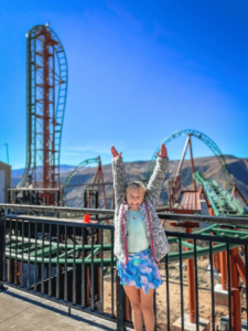 Girl in front of rollercoaster at Glenwood Caverns Adventure Park