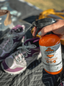 Ranger Ready Permethrin Spray bottle spraying hiking boots