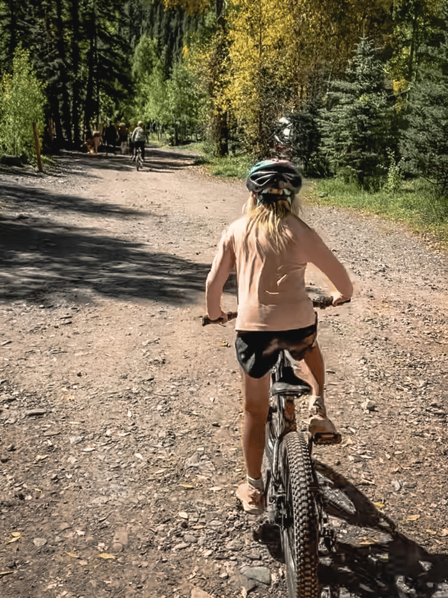 girl riding a bike at a campsite