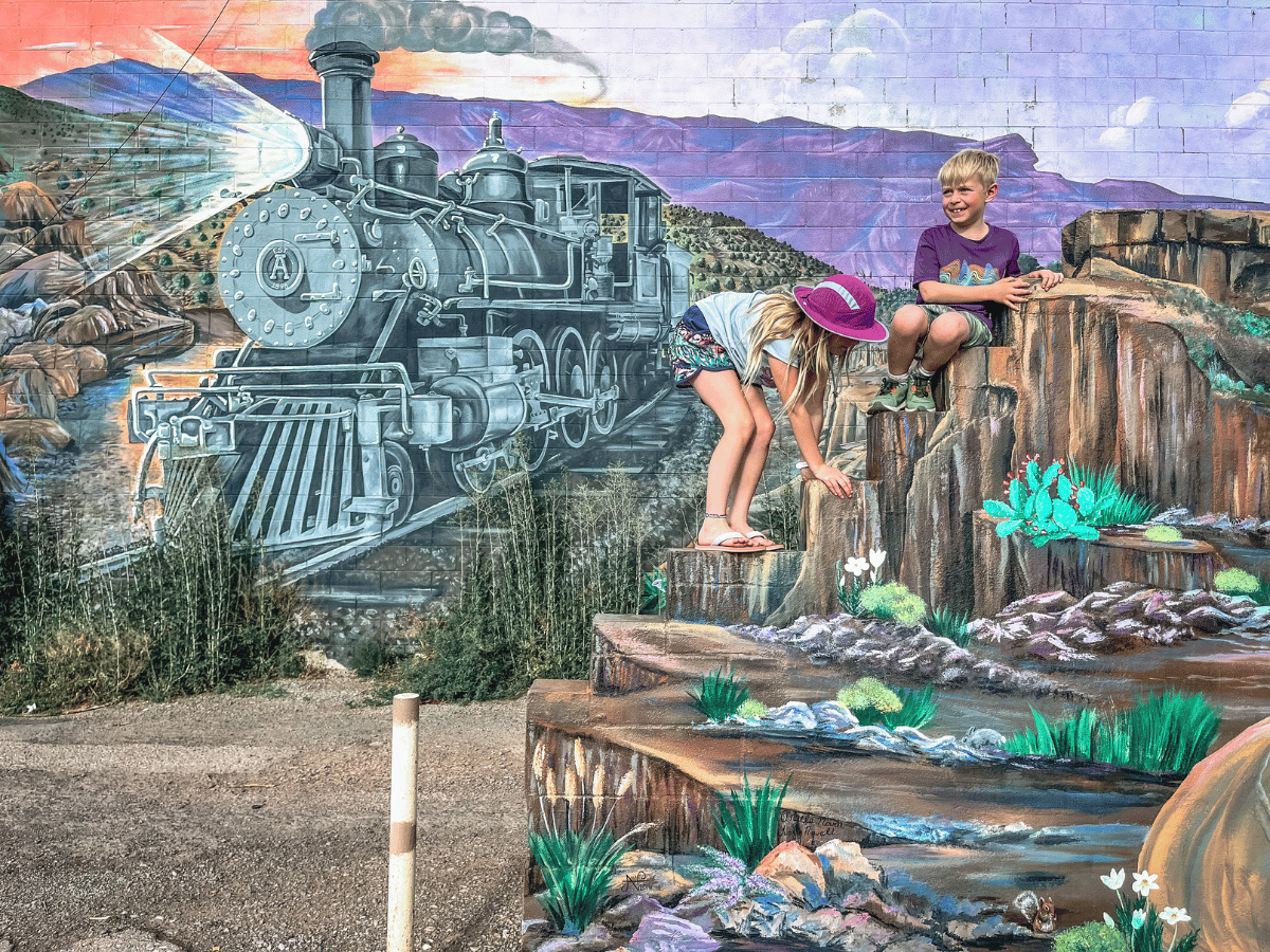 Kids climbing in front of mural in downtown Alamogordo, New Mexico